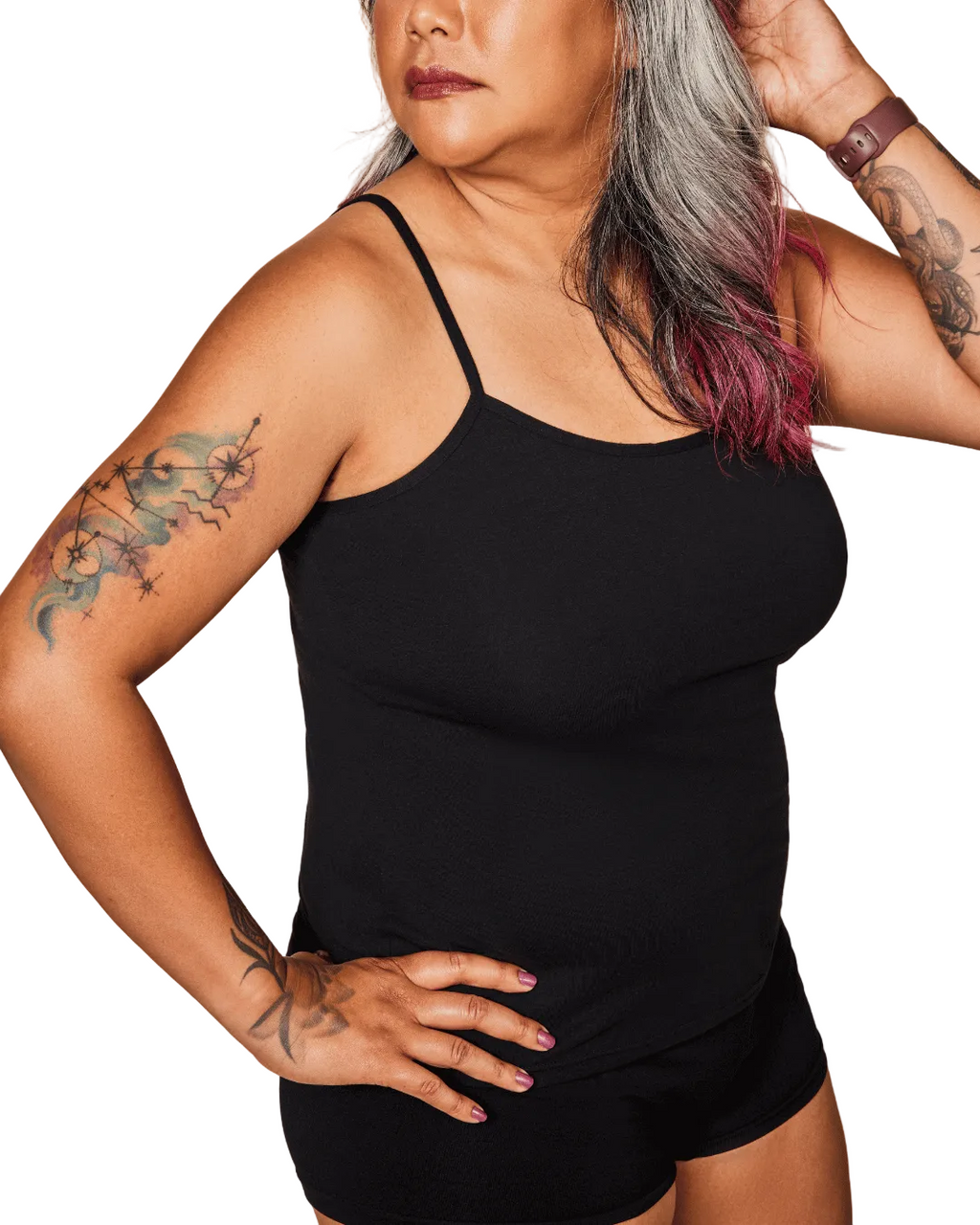 Person wearing a black tank top and shorts against a white background