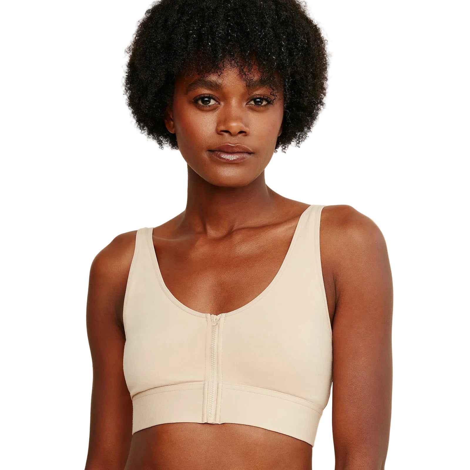 Woman wearing a beige sports bra against a white background