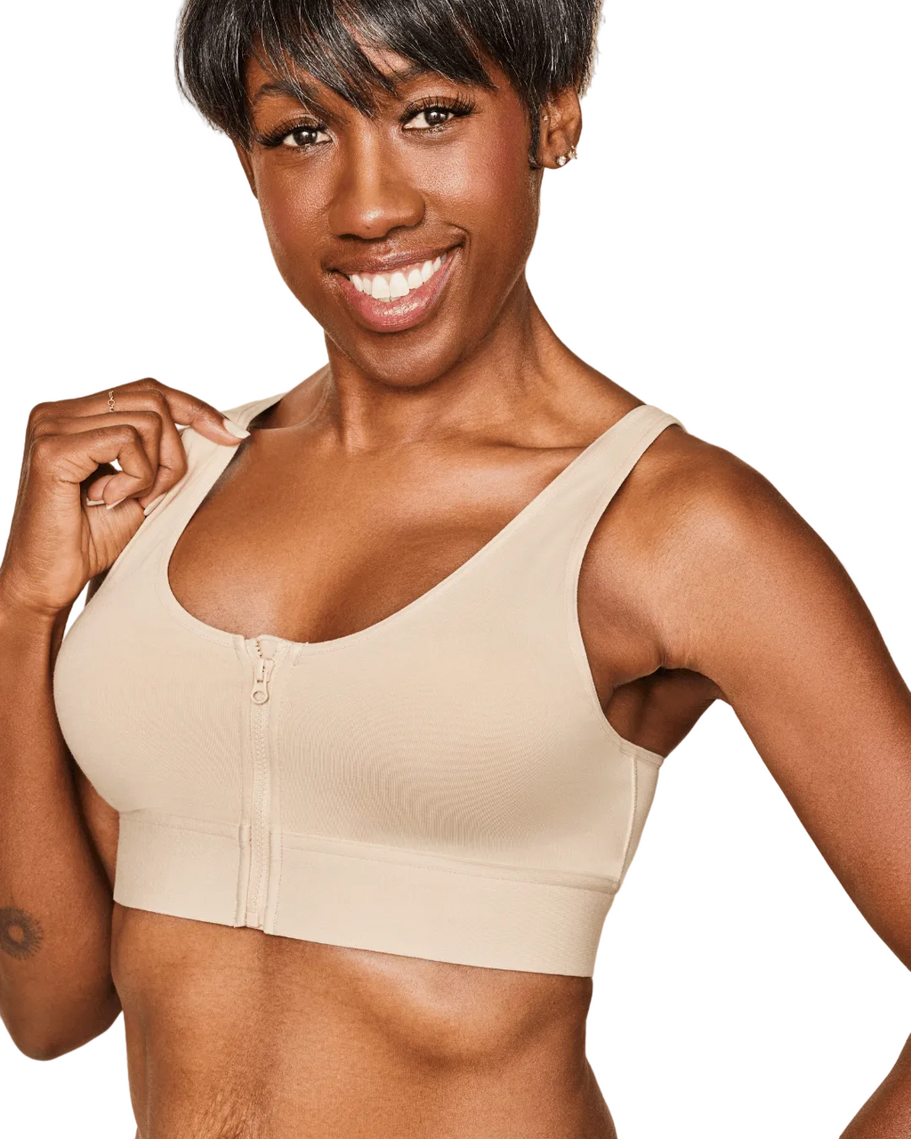 Woman wearing a beige sports bra against a white background